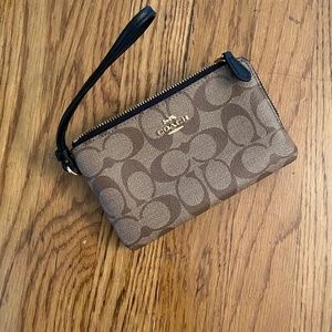 COACH double zip wallet in signature canvas.